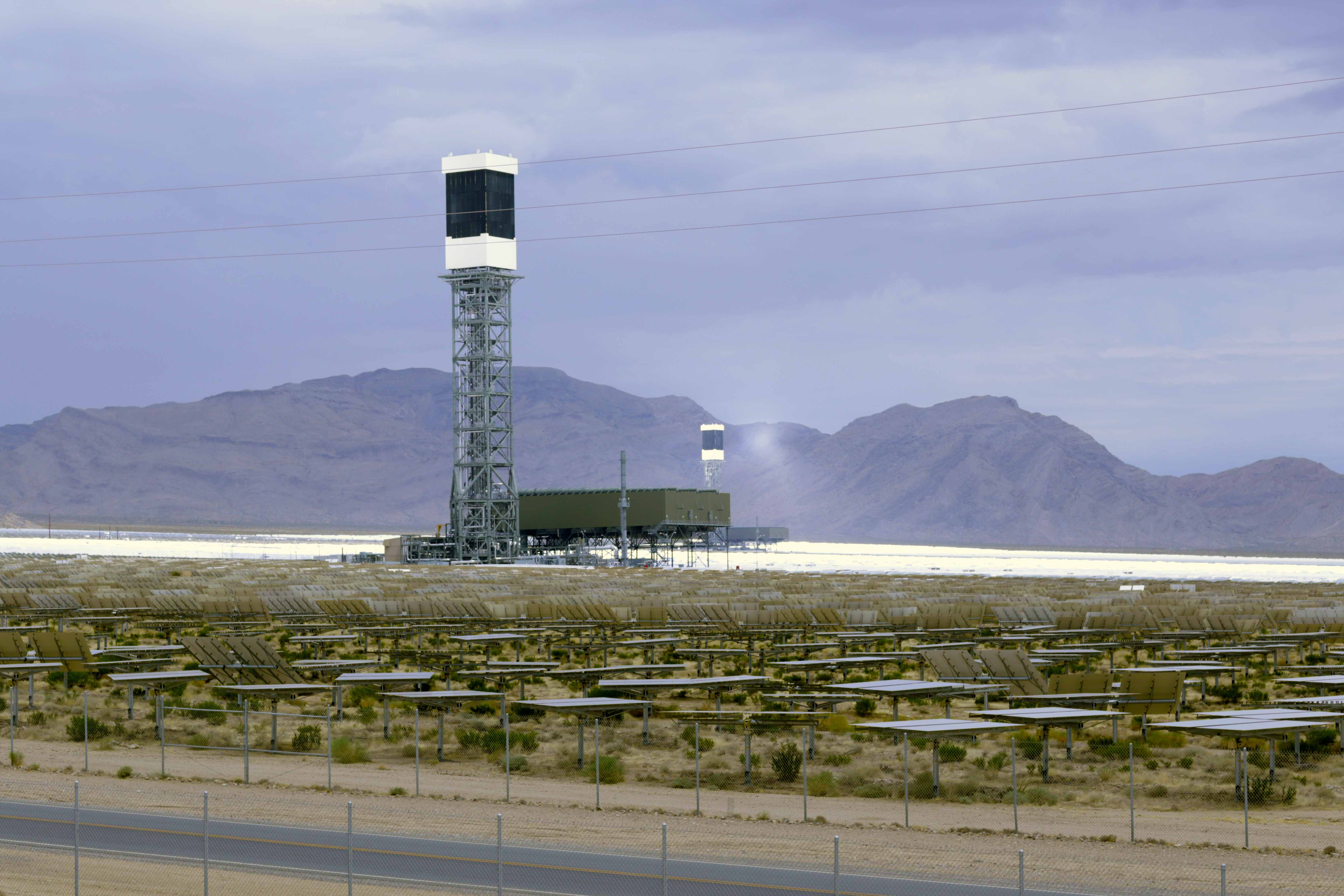Two of the 3 Ivanpah units, with the far unit being illuminated by the 